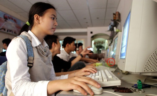 VIETNAMESE STUDENTS SURF INTERNET AT A CAFE IN HANOI.